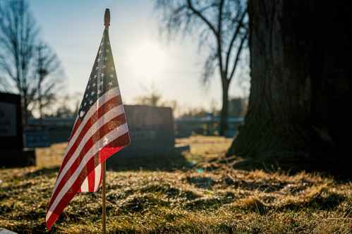 american flag on brown grass field